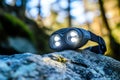 Black Headlamp with Three LEDs on a Rock Royalty Free Stock Photo