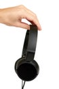 Black headphones in hand isolated on white background Royalty Free Stock Photo