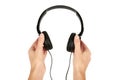 Black headphones in hand isolated on white background Royalty Free Stock Photo