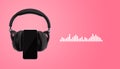 Black headphones and mobile phone isolated on pink background with music sound wave visualization Royalty Free Stock Photo