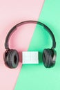 Black headphones and wooden cubes on a yellow and mint background. On cubes you can enter your date, month and day Royalty Free Stock Photo
