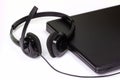 Black Headset And Notebook Computer on White Background Royalty Free Stock Photo