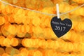 Black Heart hung on hemp rope on bokeh a golden color background Royalty Free Stock Photo