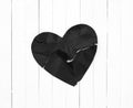 Black Heart representing Evil or Disease on White Wood Board Background with copy space. A horizontal photo