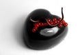 Black heart shape dessert with sweet red juice jelly caviar