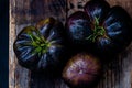 Black heirloom tomatoes on rustic vintage wooden crate Royalty Free Stock Photo