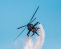 Black helicopter blowing smoke for an airplane show