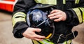 Black helmet in fireman's hand close-up Royalty Free Stock Photo