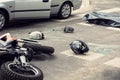 Black helmet and motorcycle on the road after fatal collision wi