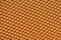 Black hex mesh on an orange sponge background Royalty Free Stock Photo