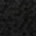 Black hexagonal tiles with a matte finish form a textured pattern in this image. The Royalty Free Stock Photo