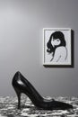 Black high heel shoe on table