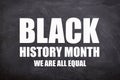 Black history month and we are all equal text in black board background. Royalty Free Stock Photo