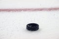 Black hockey puck on ice rink. Winter sport Royalty Free Stock Photo