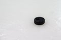 Black hockey puck on ice rink. Winter sport Royalty Free Stock Photo