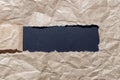 Craft paper torn in the form of a rectangle on a black background Royalty Free Stock Photo