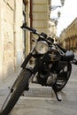 Black Honda 400 motorcycle standing in the street of old italian town. Lecce, Apulia, Italy