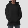 Black hoodie mockup with side slits on a girl with hands in pockets, front view closeup, product photography for design, brand