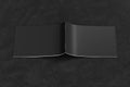 Black horizontal brochure or booklet cover mock up on black background. Brochure is open and upside down. Isolated with clipping p Royalty Free Stock Photo