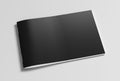 Black horizontal brochure or booklet cover mock up on white. Isolated with clipping path around brochure. Side view.