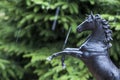 Black horse figure fir tree rain drops