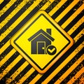 Black House with check mark icon isolated on yellow background. Real estate agency or cottage town elite class. Warning Royalty Free Stock Photo