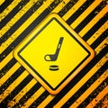 Black Ice hockey stick and puck icon isolated on yellow background. Warning sign. Vector Royalty Free Stock Photo