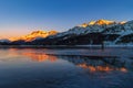 Black ice on Silser Lake (Silsersee) in winter at sunset Royalty Free Stock Photo