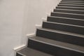 Black indoor stairs at white wall