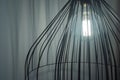 Black interior design fancy lamp with shining light bulb and white curtains in the background Royalty Free Stock Photo