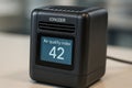 Black ionizer device displays an air quality index of 42, standing on a smooth surface in a clean modern environment Royalty Free Stock Photo