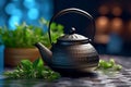 Black iron asian teapot with sprigs of mint for tea Royalty Free Stock Photo