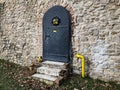 Black iron door to castle with ornaments and windows behind bars, Pezinok, Slovakia