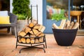 black iron fire pit with stack of logs ready for burning Royalty Free Stock Photo