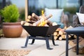 black iron fire pit with stack of logs ready for burning Royalty Free Stock Photo