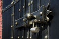 Black iron gate, brass squares and a lock with latch Royalty Free Stock Photo
