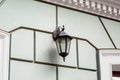 Black iron hanging retro street lighting lantern. Royalty Free Stock Photo