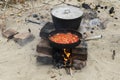 black iron pan with roasting vegetables and big cooking pot with soup Royalty Free Stock Photo