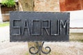 Black iron rectangualar sacrum sign