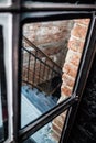 Black iron staircase brick wall, creative space. loft office. coworking. view through glass door Royalty Free Stock Photo