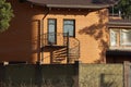 Black iron staircase on the brown brick wall of the house Royalty Free Stock Photo