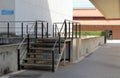 Black iron steps, entrance to the building. Iron banister. Elements railing of a back door of building.