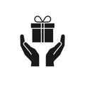 Black isolated icon of gift box in open hands on white background. Silhouette of gift box and two hands. Give, make a present
