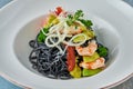 Black Italian seafood pasta with shrimps, cherry tomatoes and