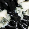 Black Italian spaghetti  pasta with blue cheese with mold. Square photo. Royalty Free Stock Photo