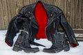 Black jacket with a red lining and boots in the snow Royalty Free Stock Photo