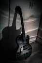 Black jazz archtop guitar with holes. hollow steel-stringed acoustic or semiacoustic Royalty Free Stock Photo