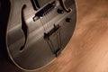 Black jazz archtop guitar with holes. hollow steel-stringed acoustic or semiacoustic
