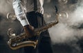 Black jazz musician with saxophone on the stage