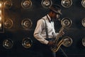 Black jazzman in hat plays the saxophone on stage Royalty Free Stock Photo